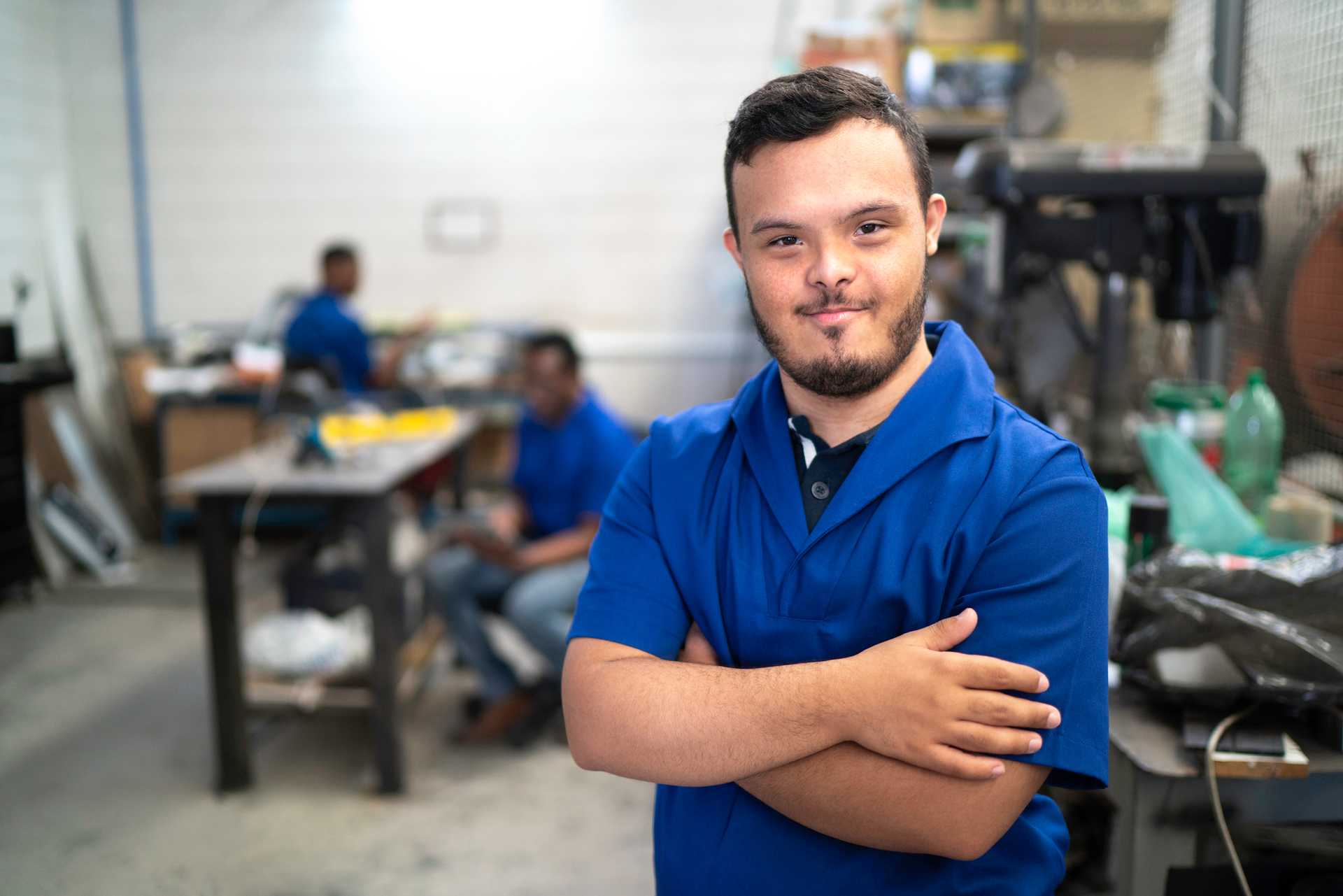 Portrait of smiling special needs employee in an industrial setting