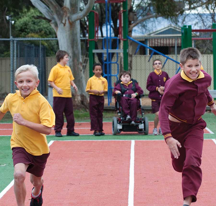 Two young boys in a race in the playground at school