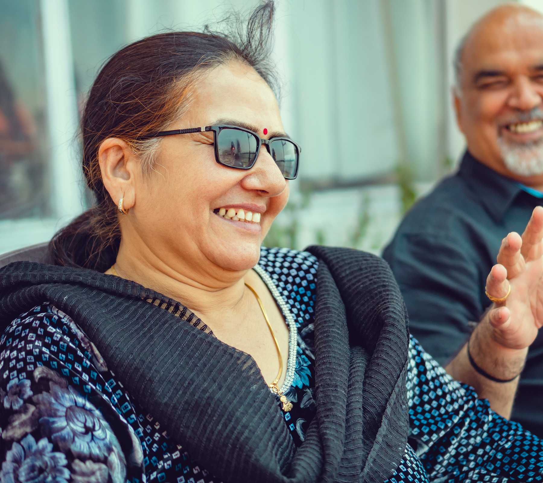 An Asian/Indian happy retired couple enjoys a leisure outing in outdoor at a resort.