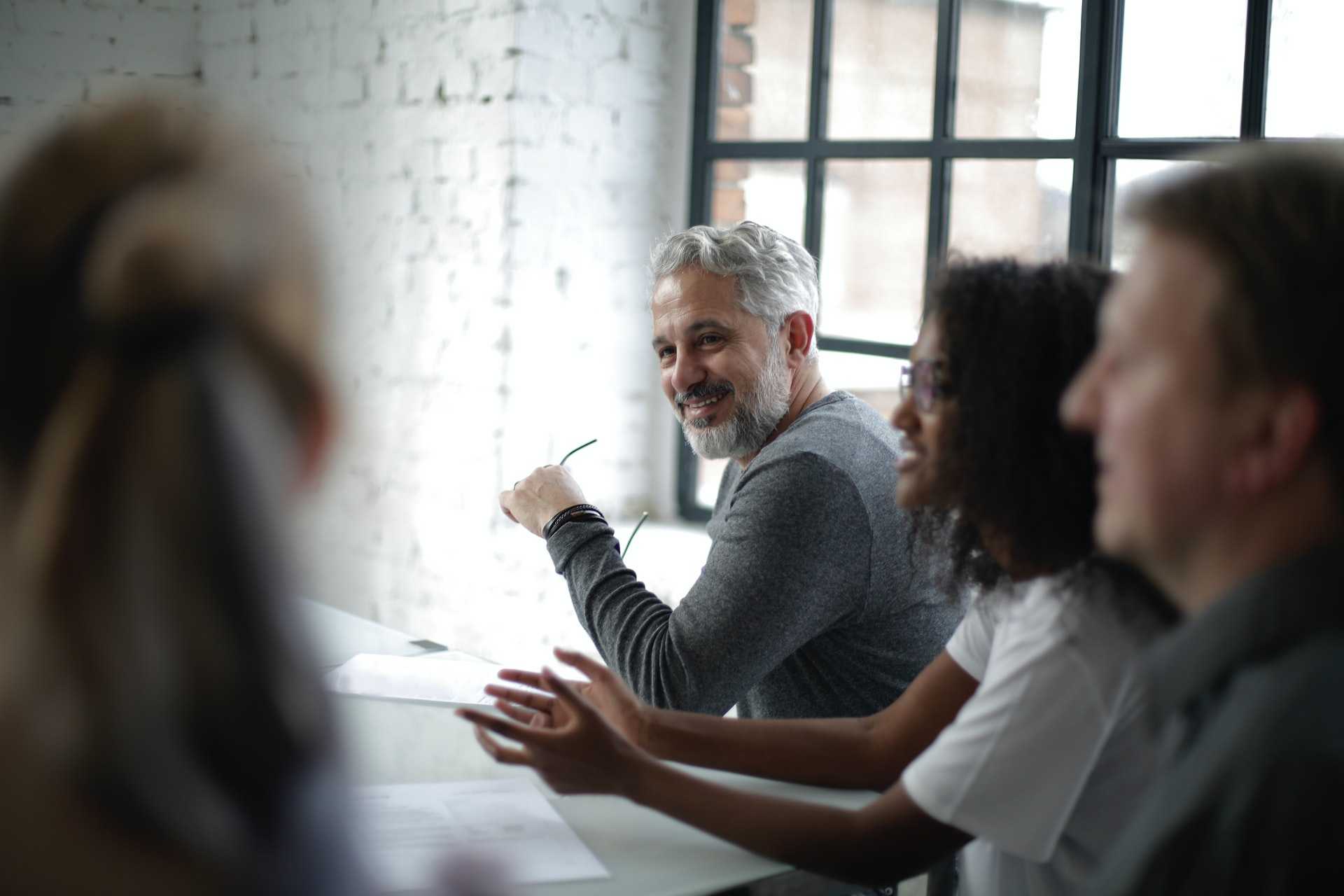 A group of people sitting around a table having a discussion