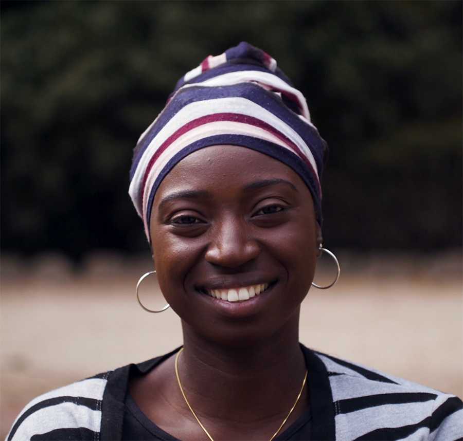A young African Australian woman smiles at the camera